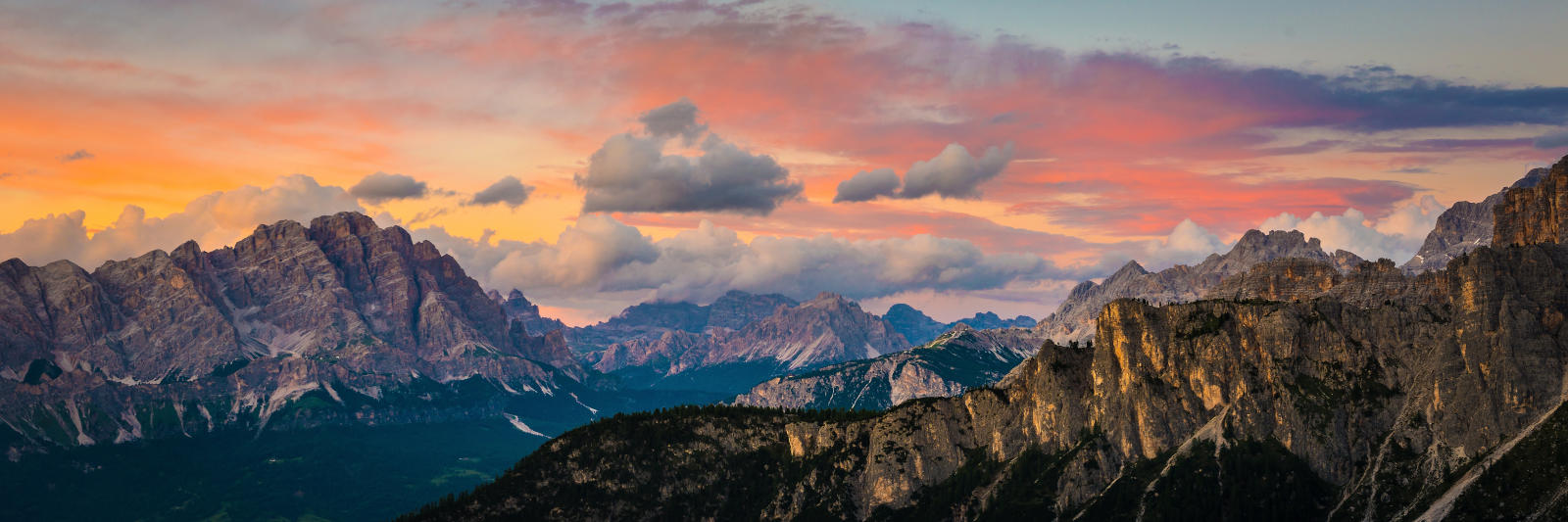 Stunning summer sunset glow over the Tofane mountain group during the mid-August peak season