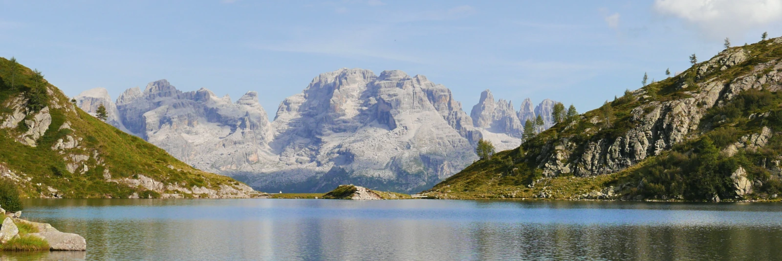 The rugged peaks of Brenta Dolomites reflected in Lago Nero lake within the Presanella mountain group